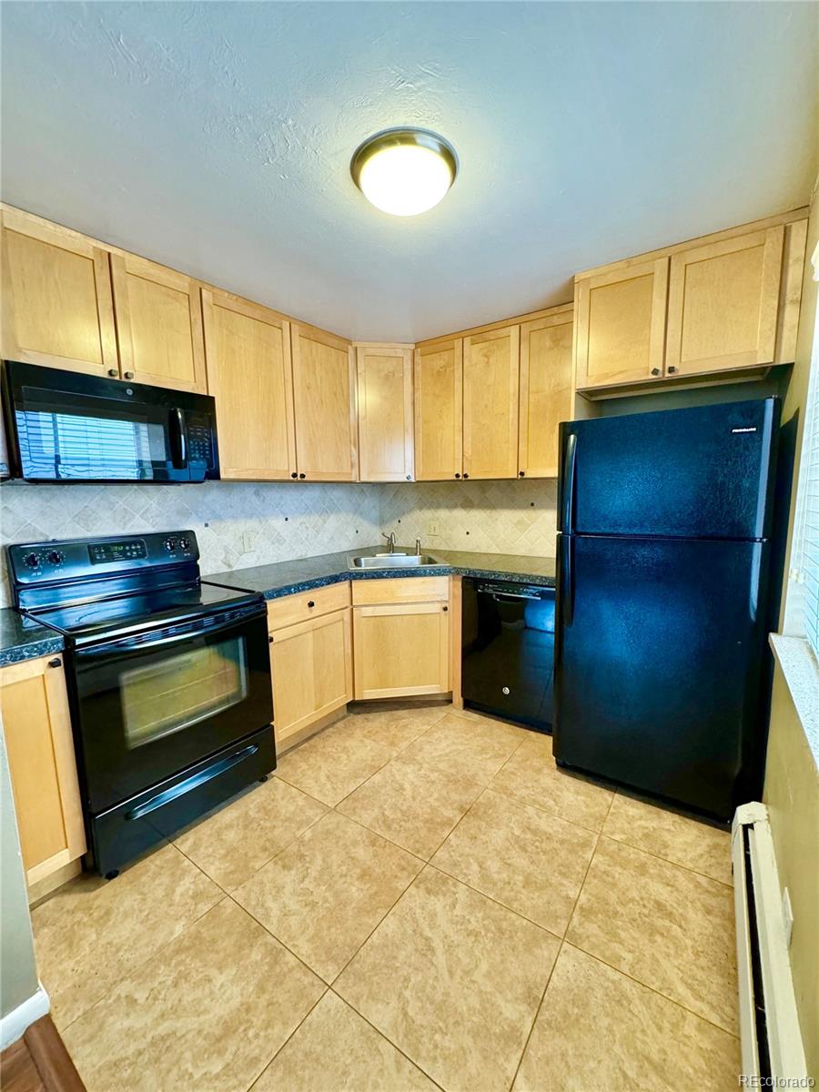 a kitchen with a sink cabinets and appliances