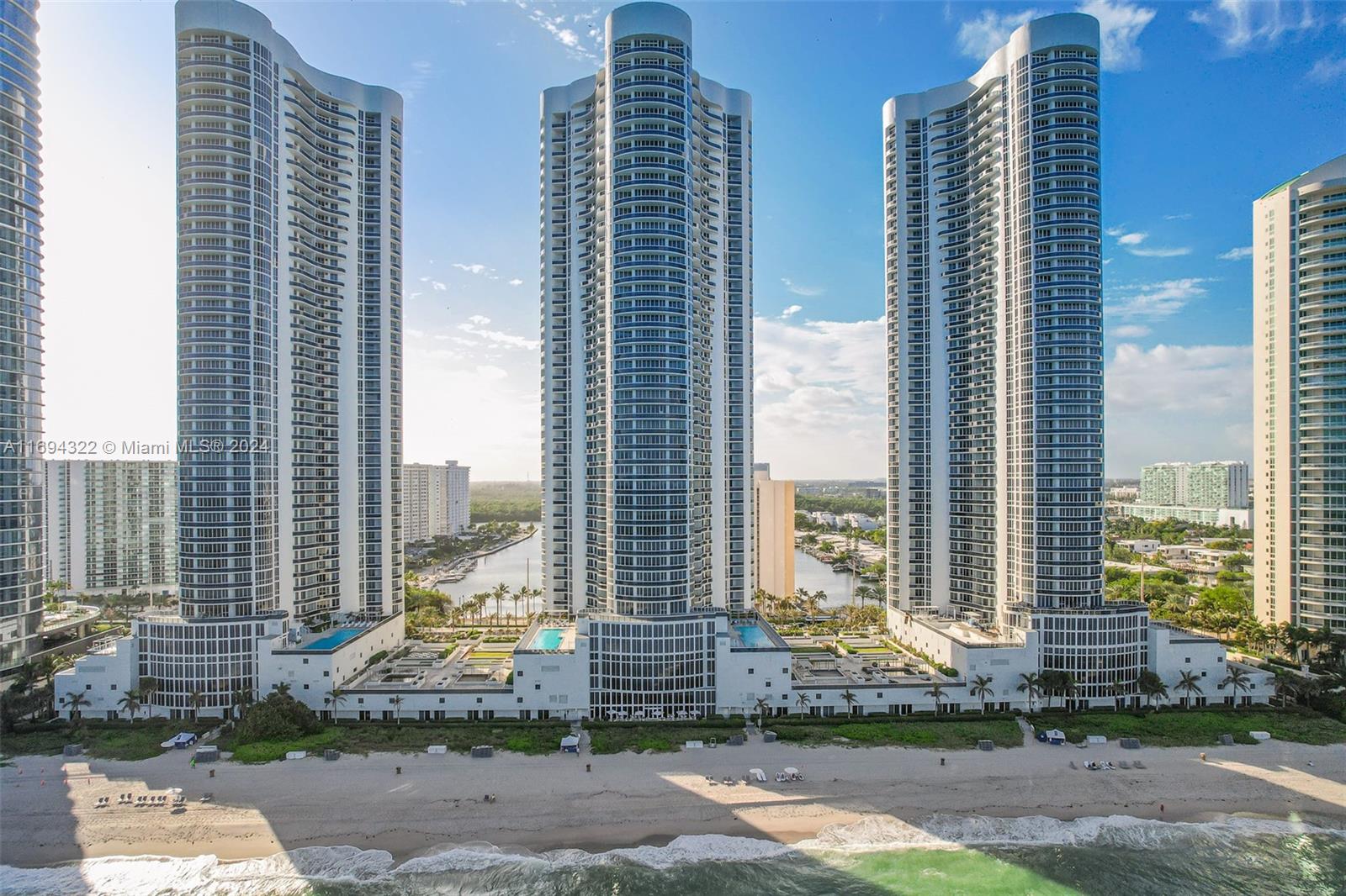 a front view of a residential apartment building with a yard