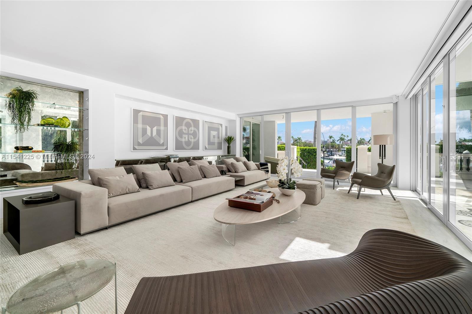 a living room with furniture kitchen view and a window