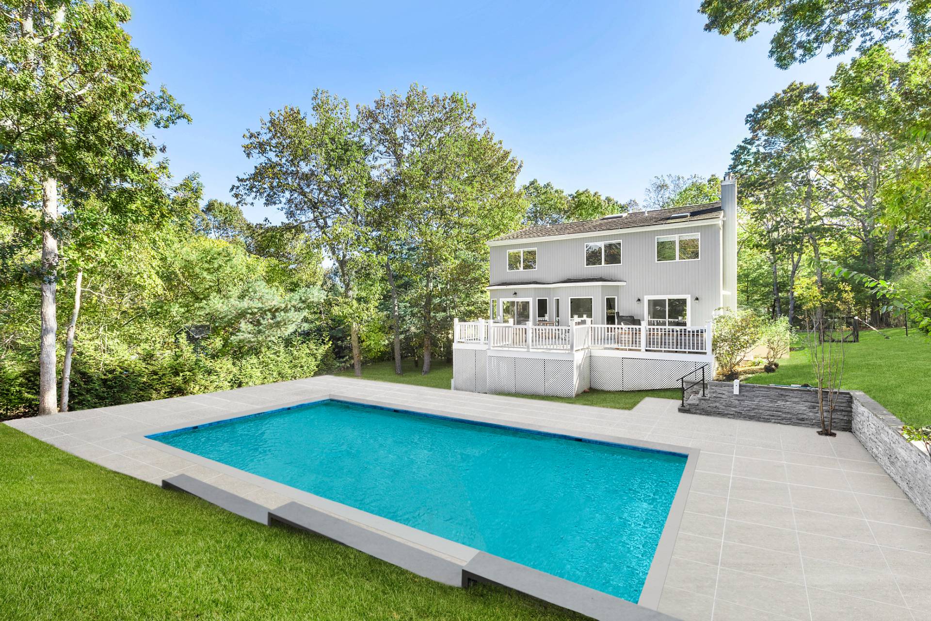 a view of a house with pool and a yard