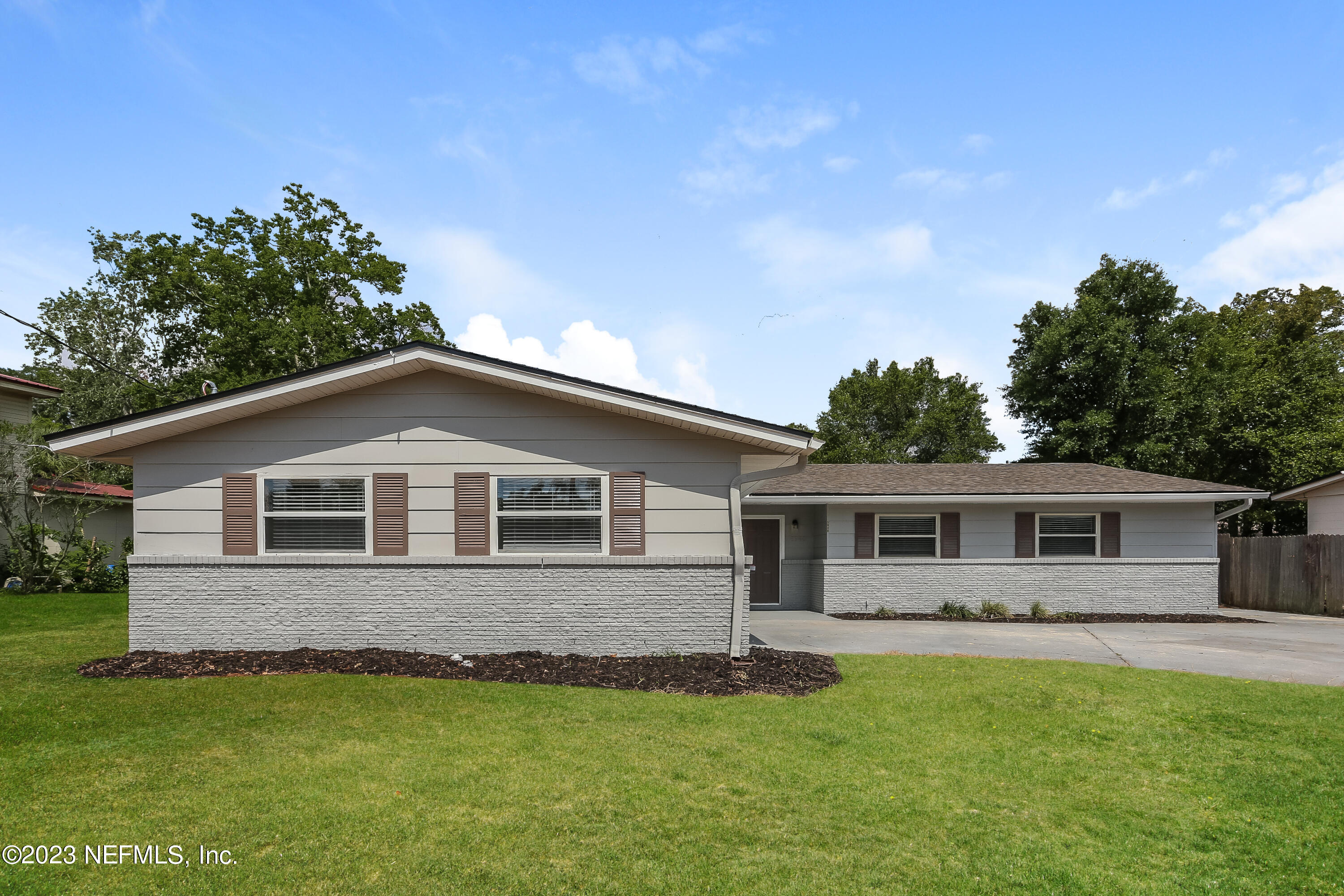 a front view of house with yard and green space