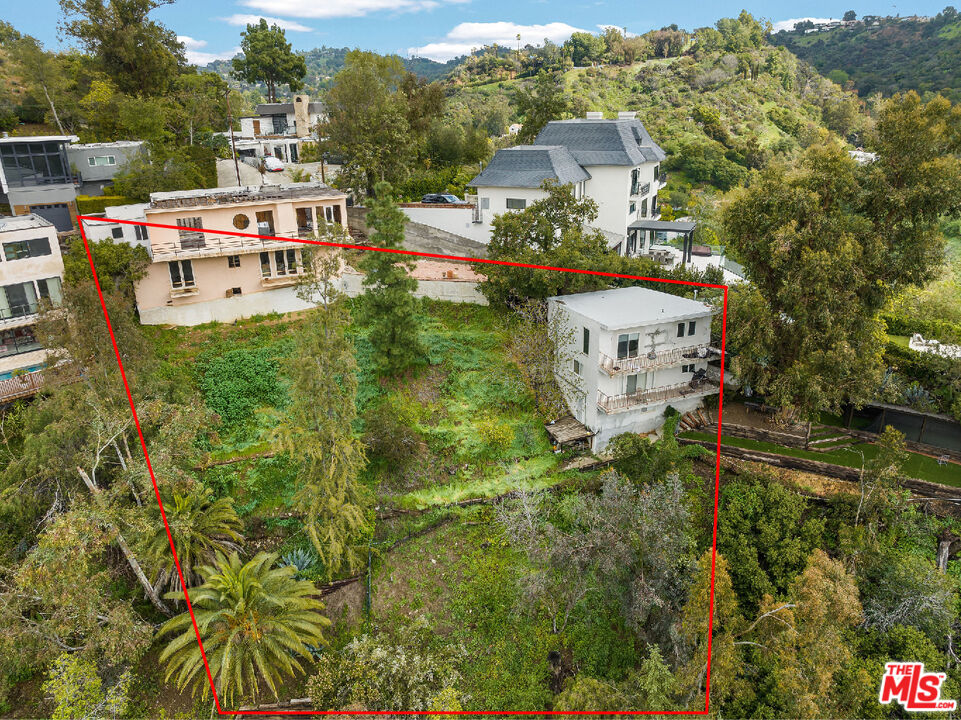 an aerial view of a house with yard swimming pool and outdoor seating