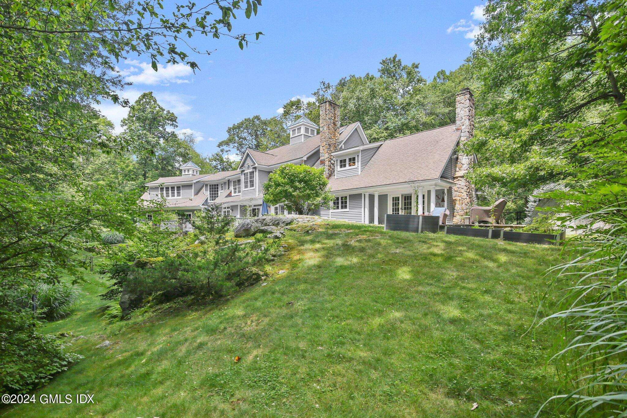 a aerial view of a house with a yard and tree s