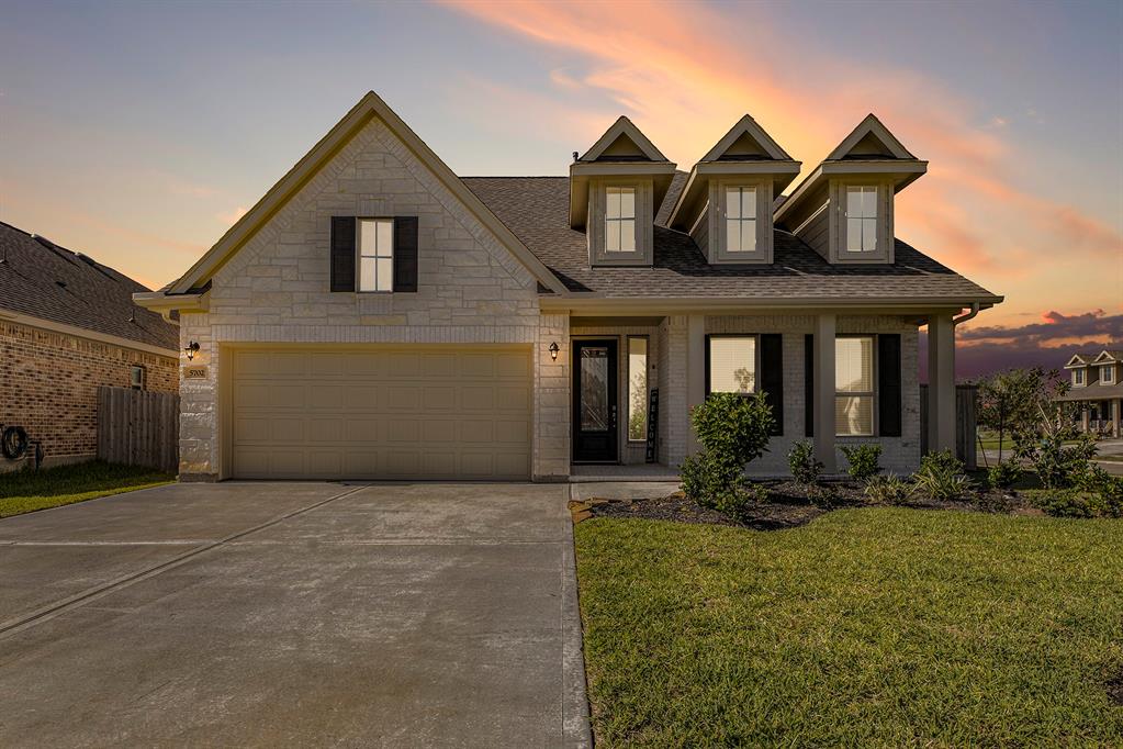 a front view of a house with a yard and seating space