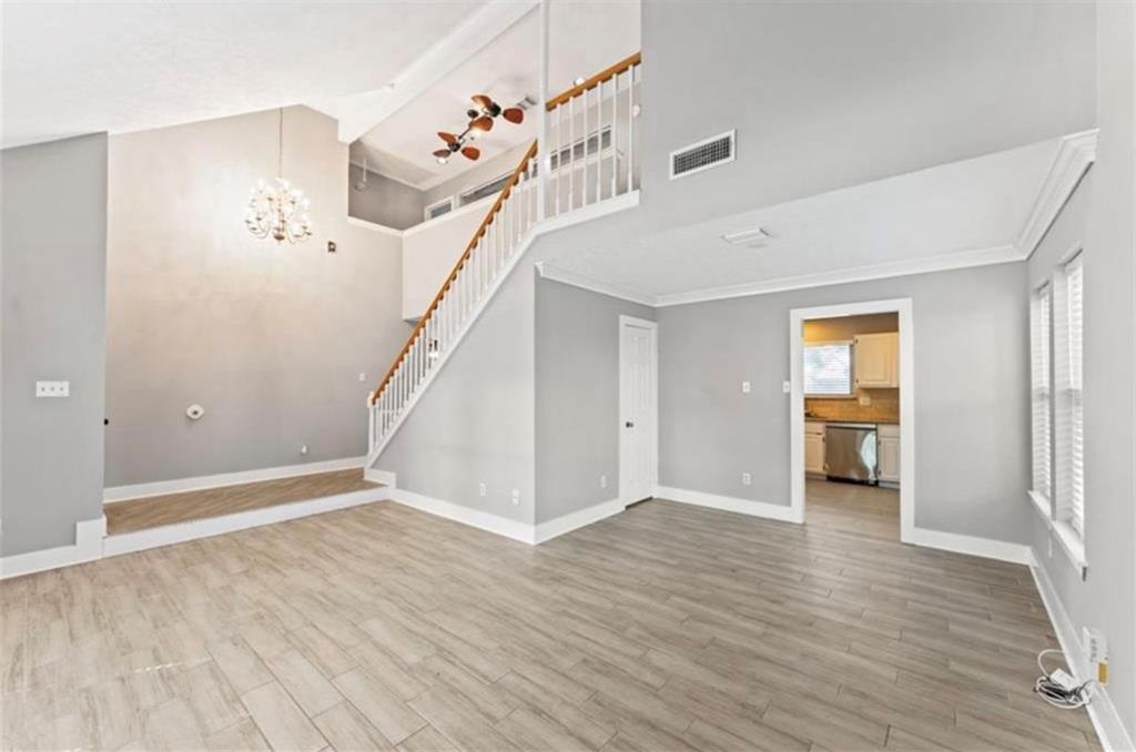 a view of a room with wooden floor and stairs