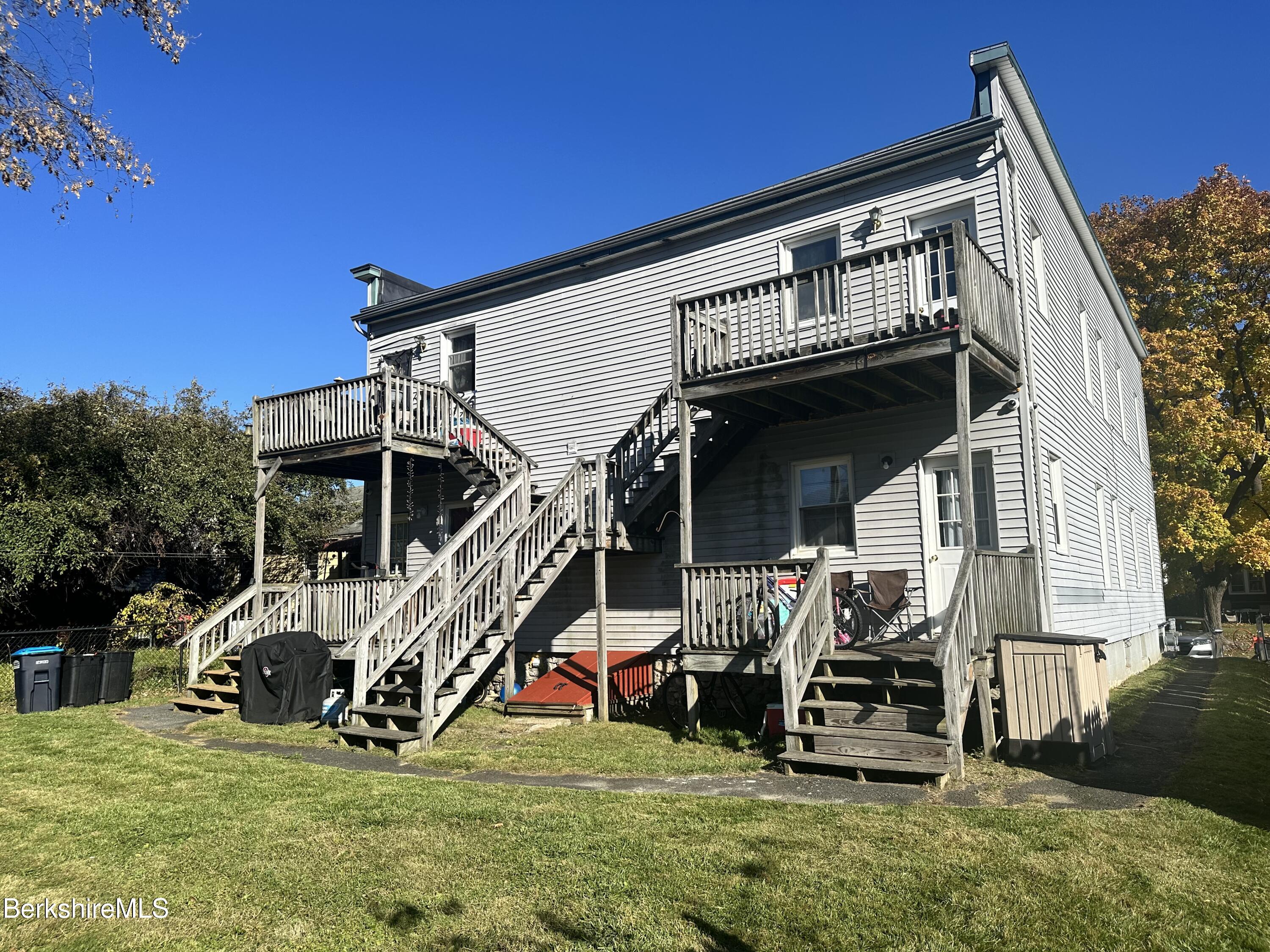 a view of a house with patio and a yard