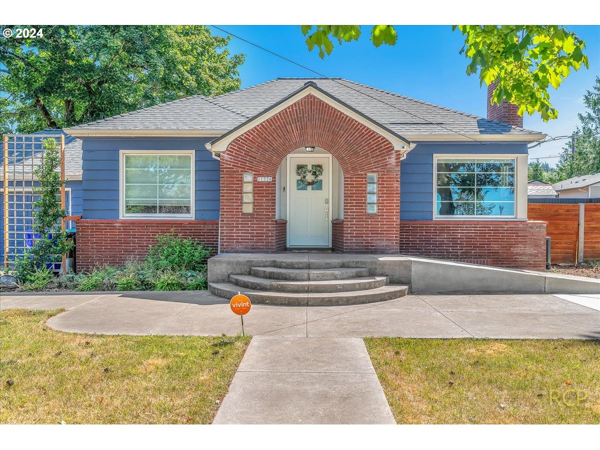 a front view of a house with a garden