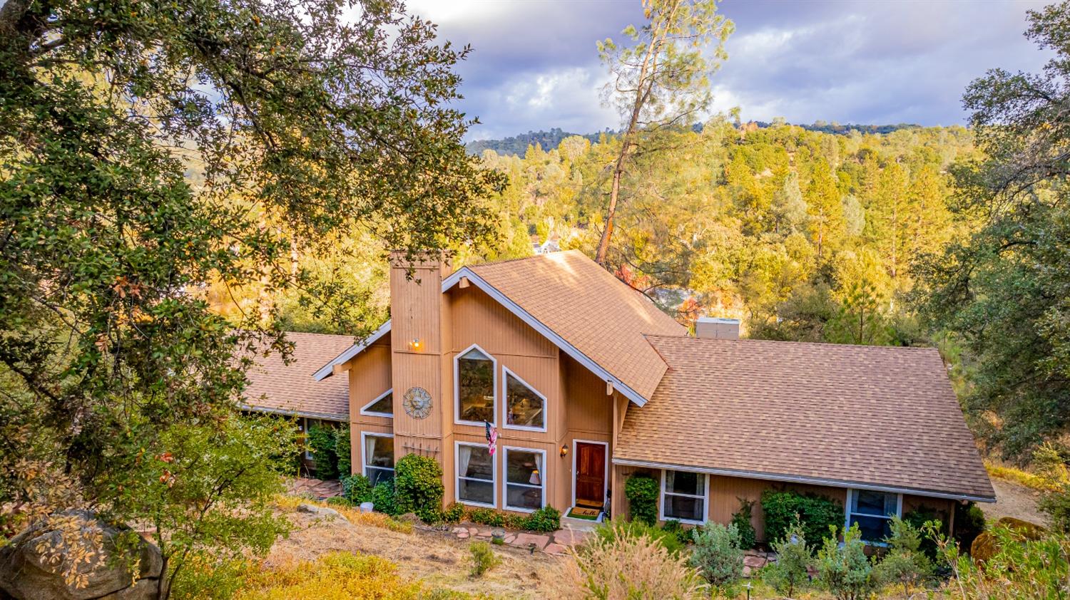 a view of a house with a large tree