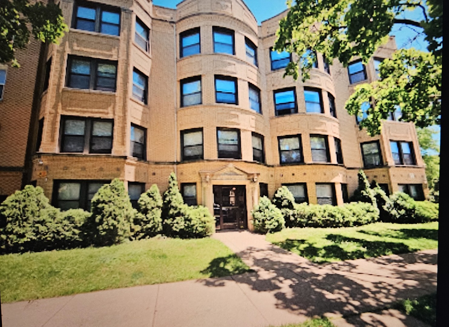 a front view of a building with garden