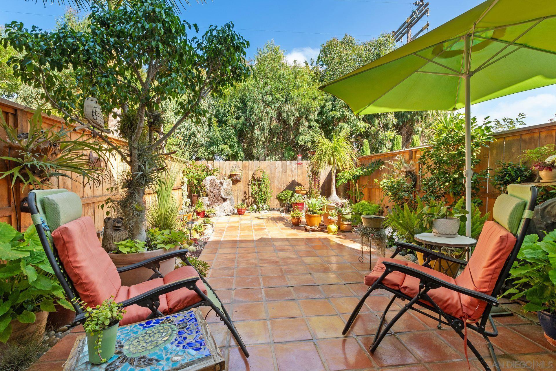 a view of an outdoor sitting area with furniture and umbrella