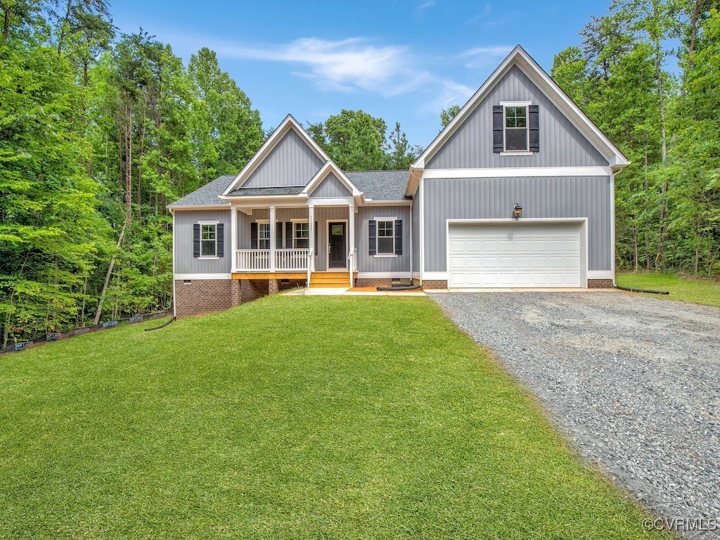 a front view of a house with a yard and trees