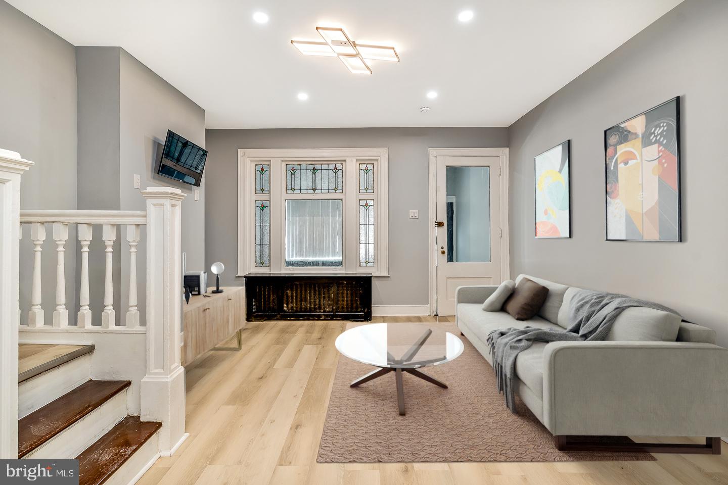 a living room with furniture a fireplace and a flat screen tv