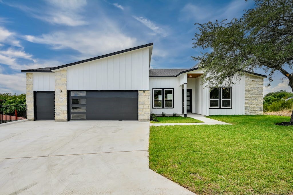 a front view of a house with a yard and garage