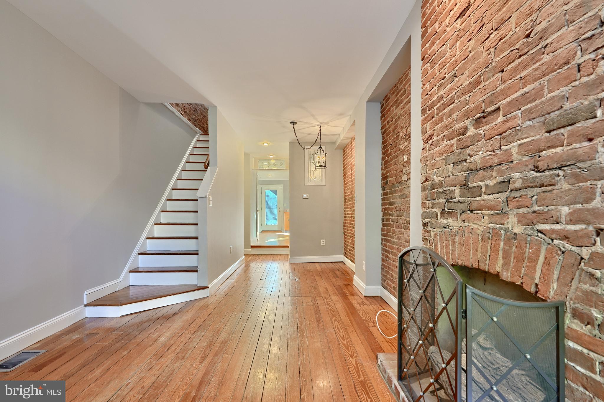 a view of a room with wooden floor and stairs