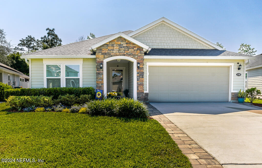 a front view of a house with a yard and garage