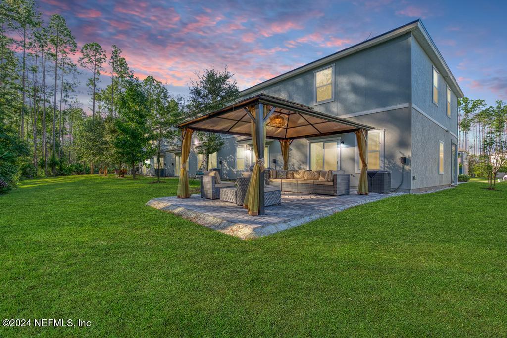 a view of a house with a yard porch and sitting area