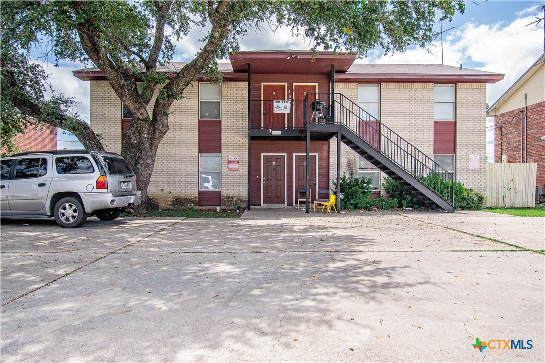 a front view of a house with parking area