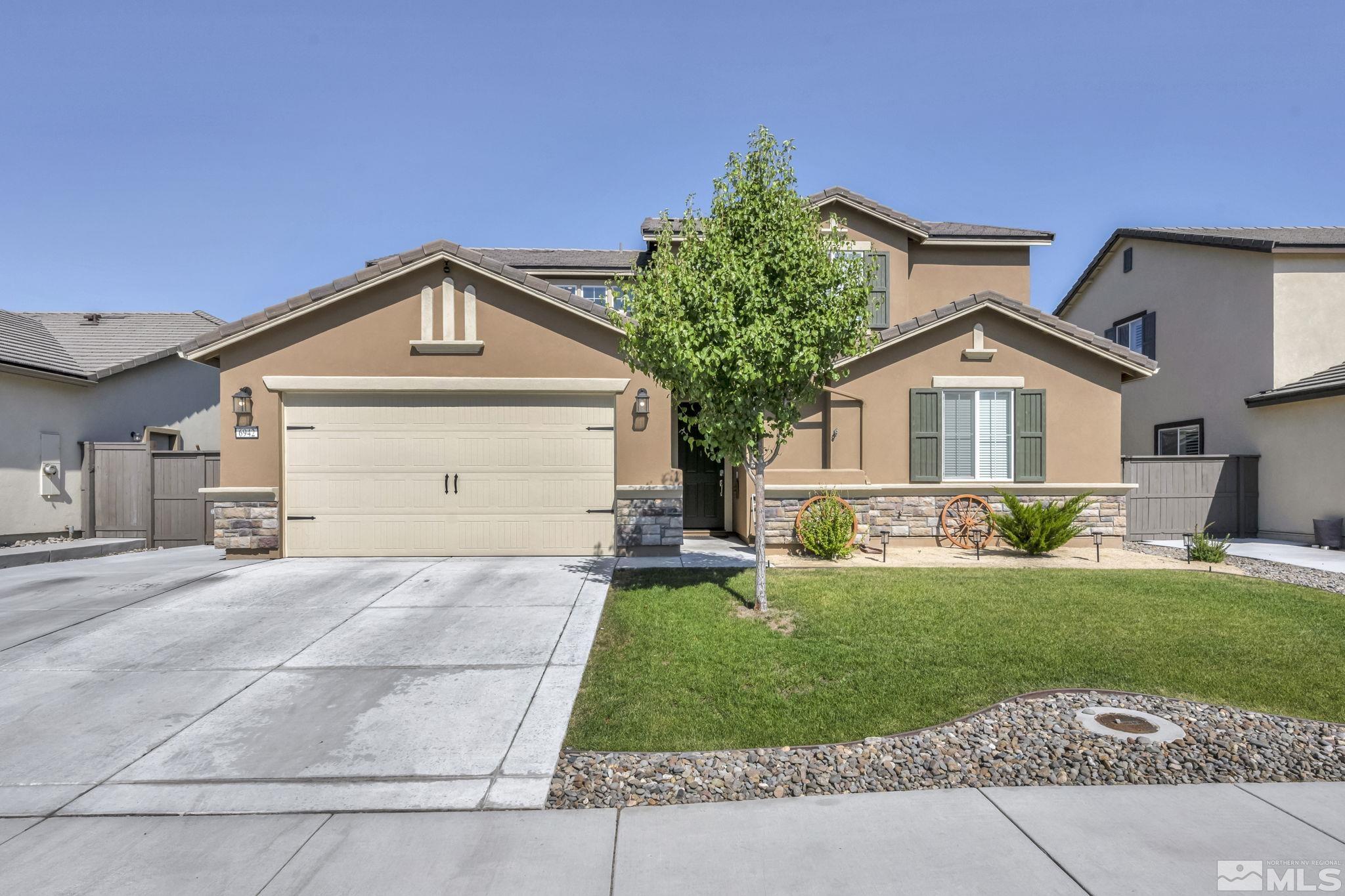 a front view of a house with a yard and garage