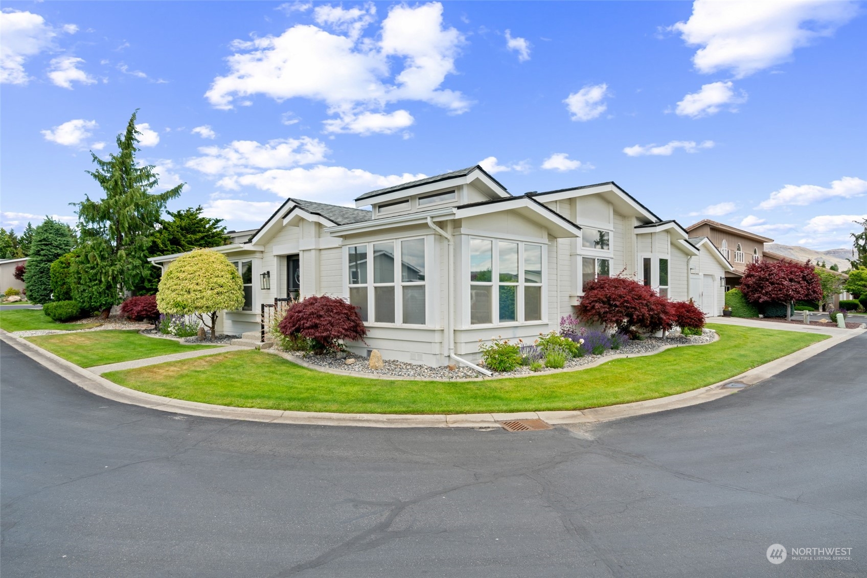 a front view of a house with a garden and plants