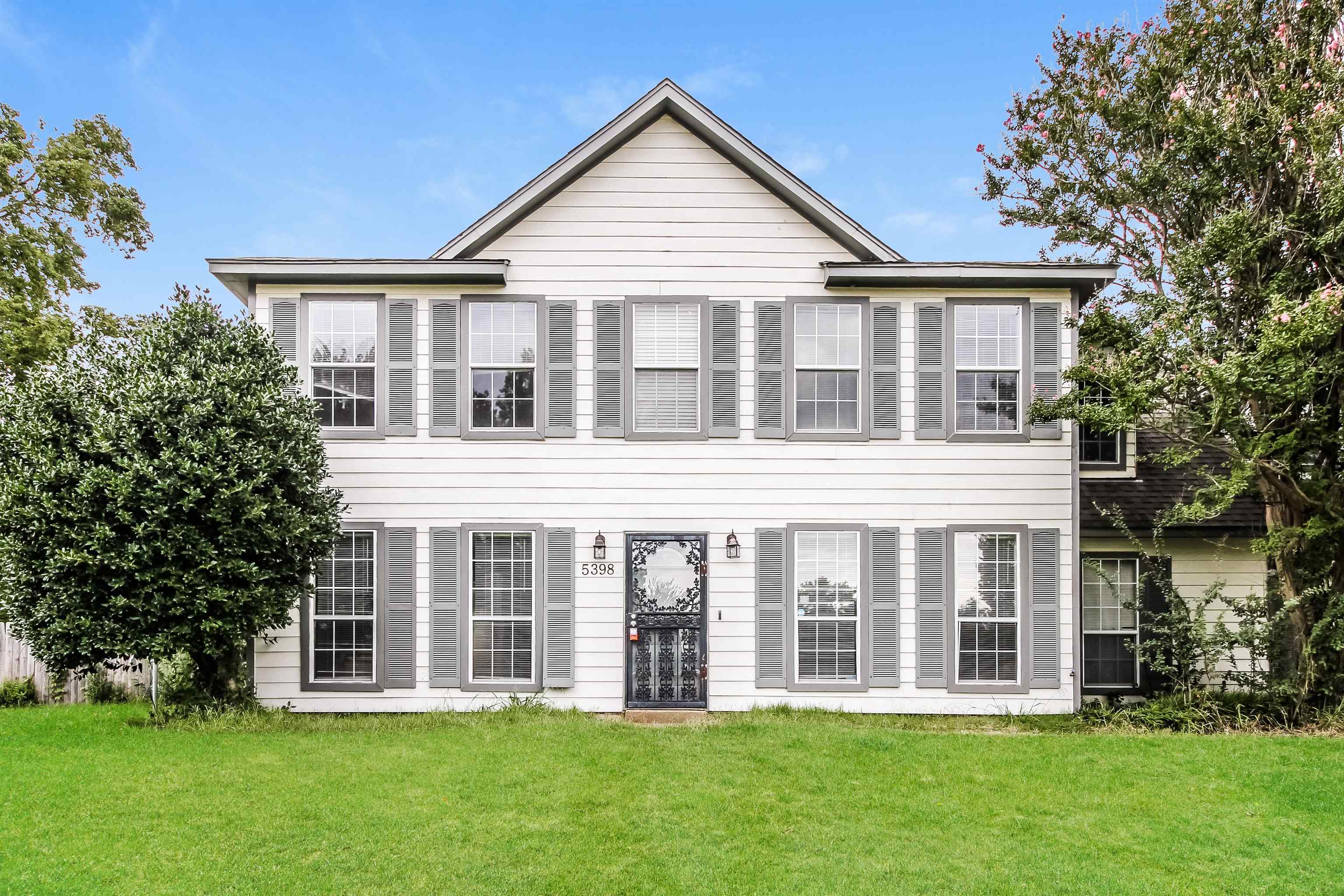 front view of a house with a yard