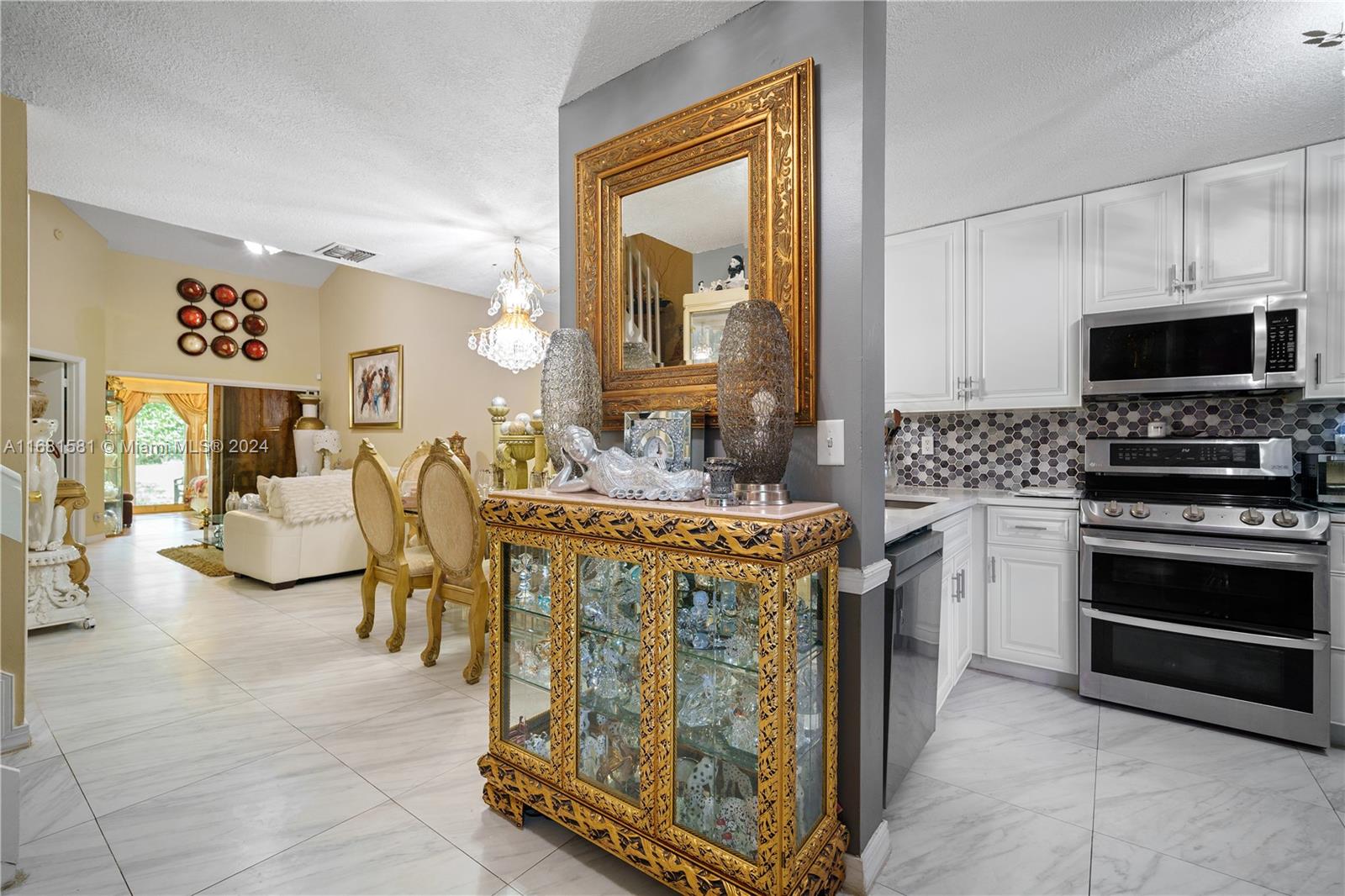 a kitchen with sink cabinets and stove top oven