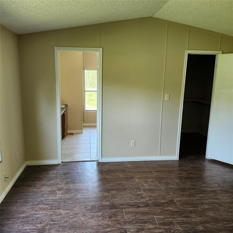 a view of a room with wooden floor and bench