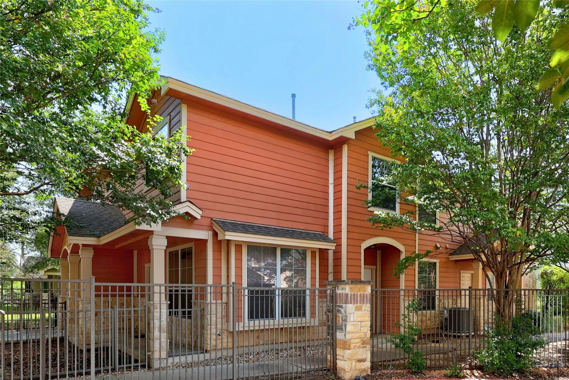 front view of a house with a blue tree