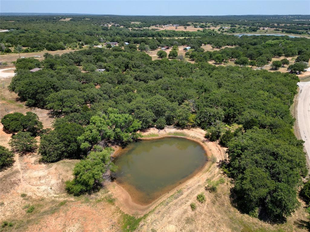 an aerial view of a house with a yard and lake view