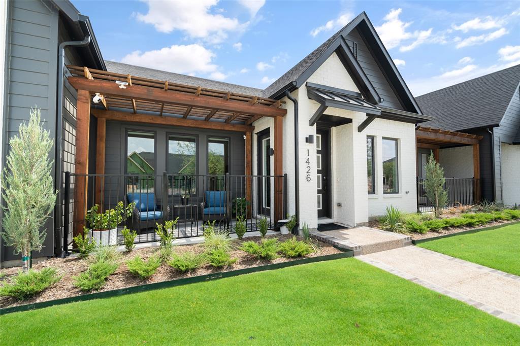 a front view of house with a garden and patio