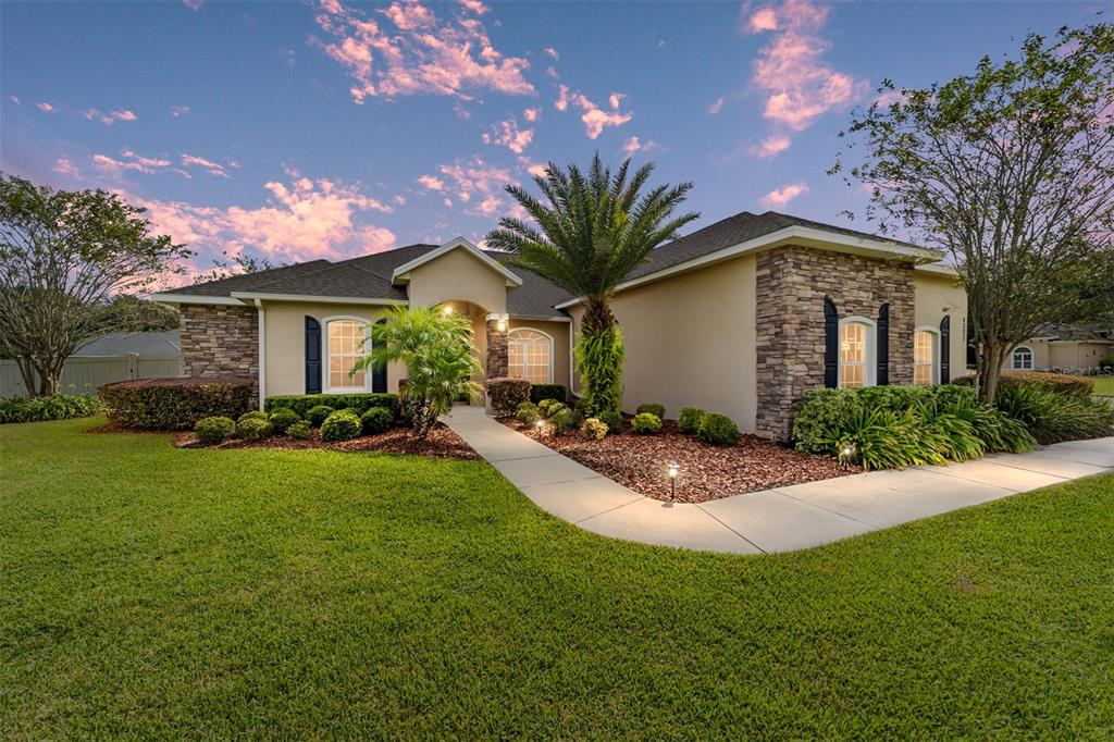 a front view of house with yard and green space