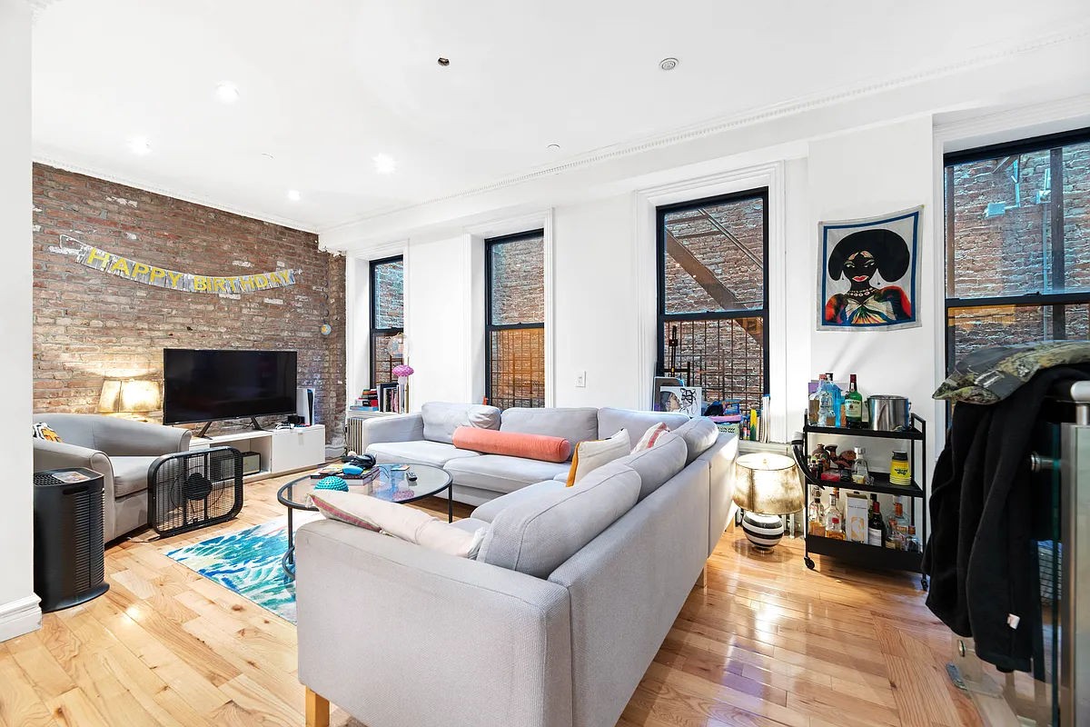 a living room with fireplace furniture and a flat screen tv