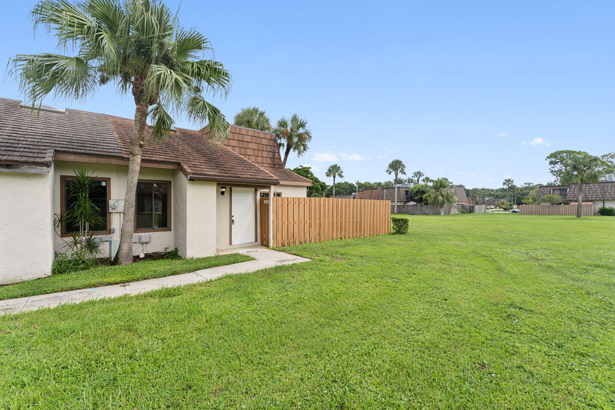 a front view of a house with a garden and yard