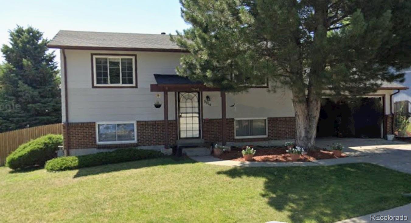 a front view of a house with garden and patio