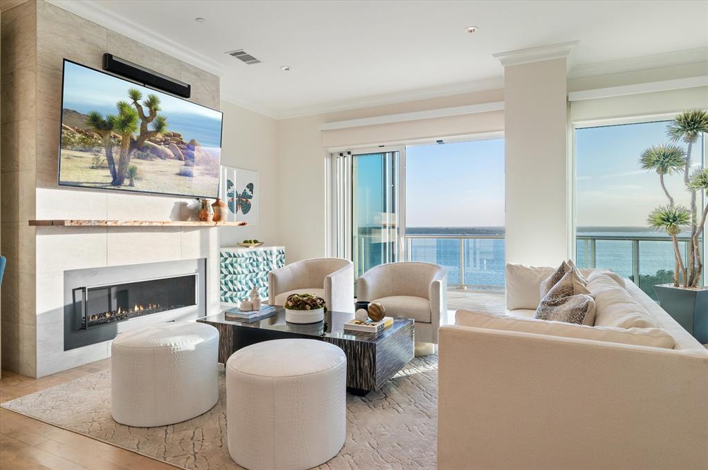 a living room with furniture a fireplace and a large window