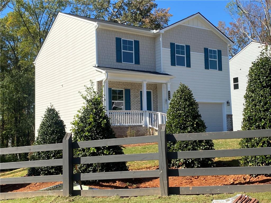 a front view of a house with trees