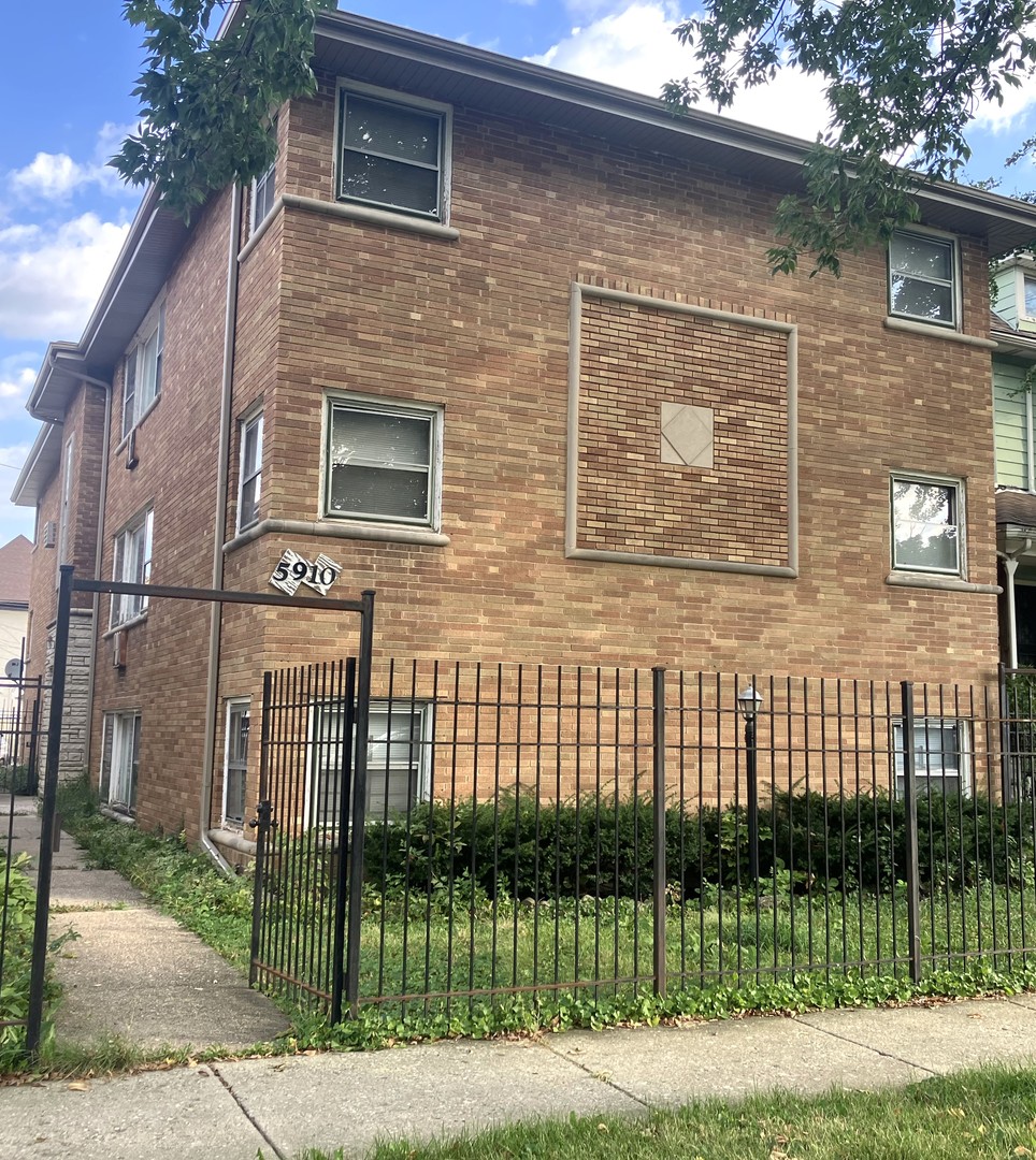 a view of a brick house with large windows