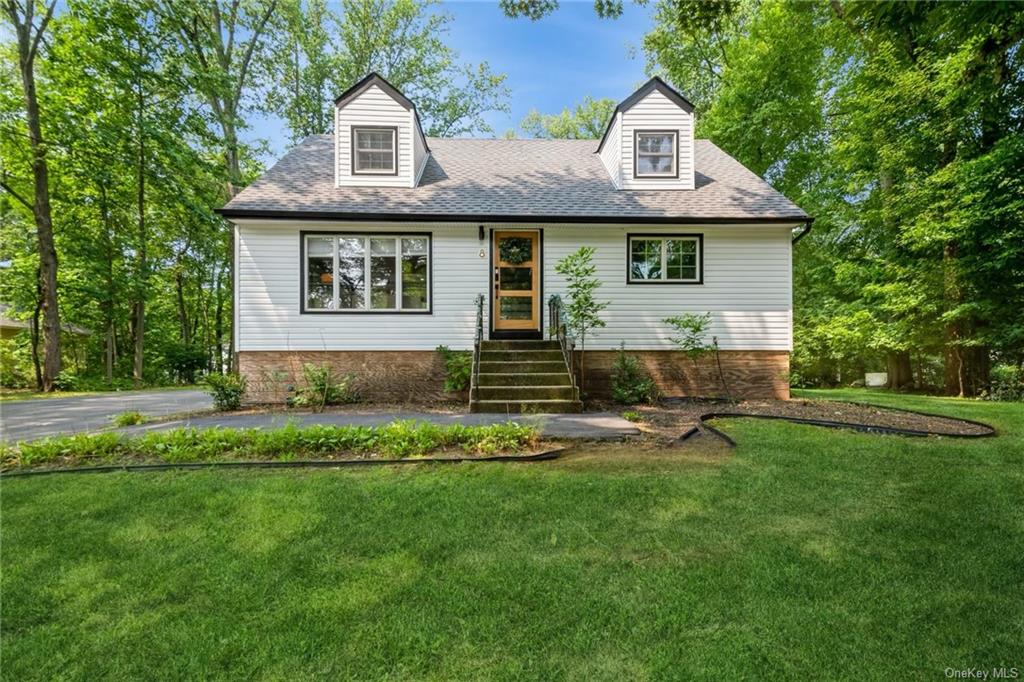 a front view of a house with a garden and porch