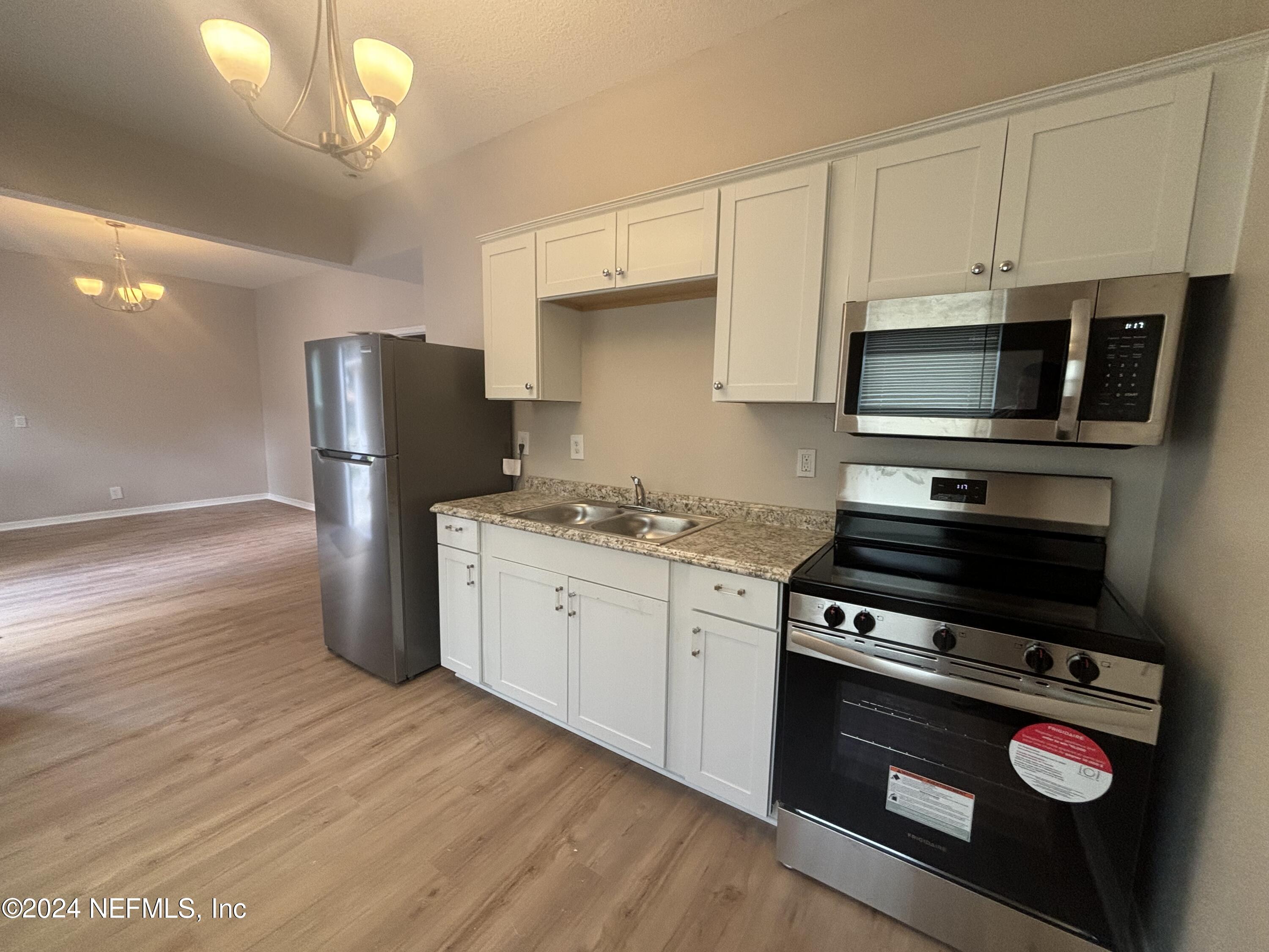 a kitchen with a refrigerator stove and microwave