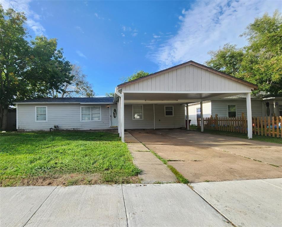 a front view of a house with a garden and yard