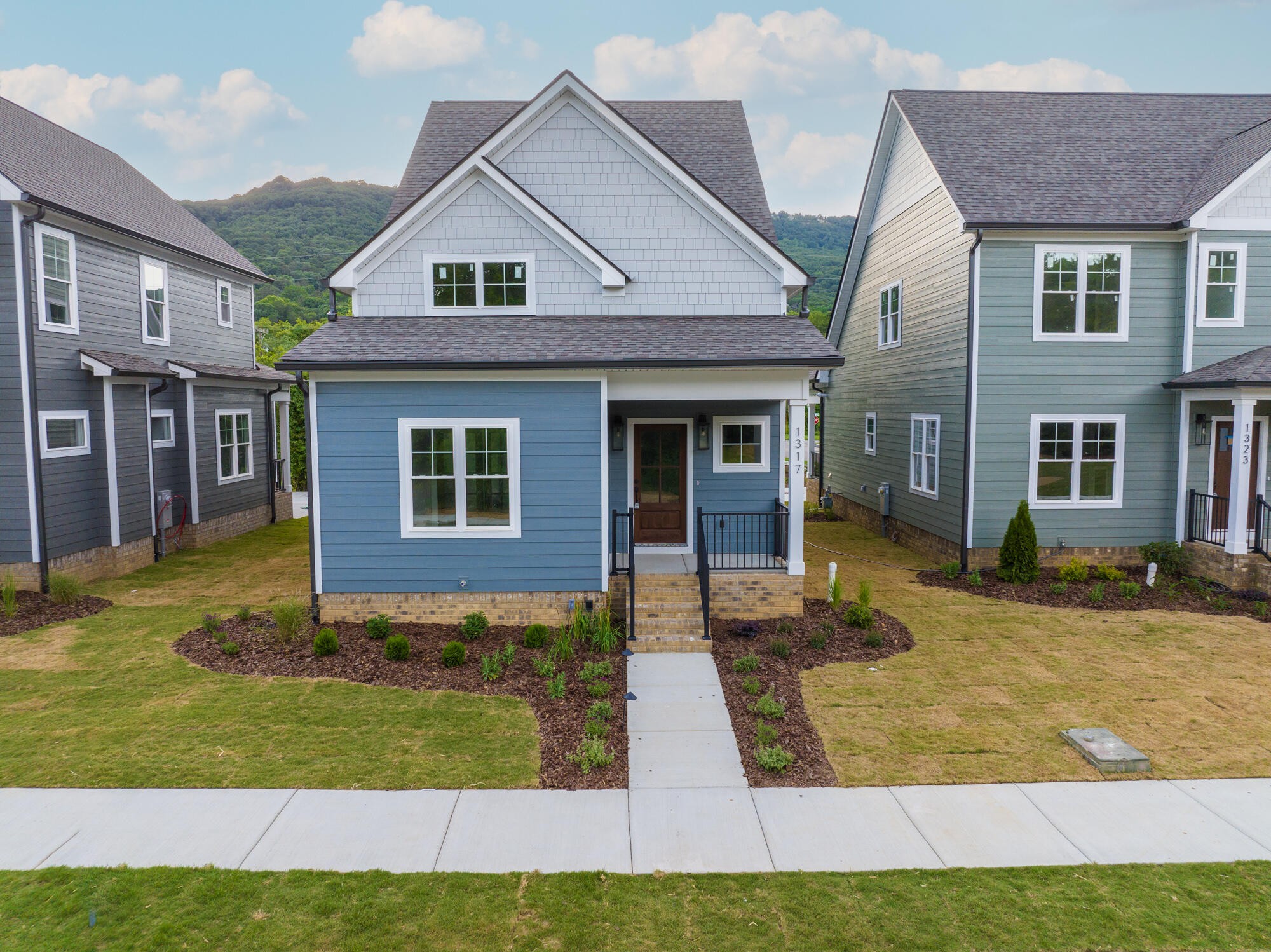 a view of a yard in front of a brick house