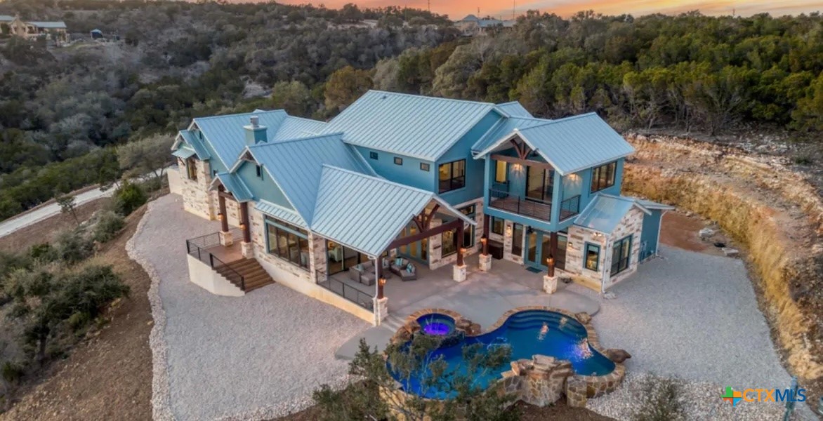 an aerial view of a house with a big yard