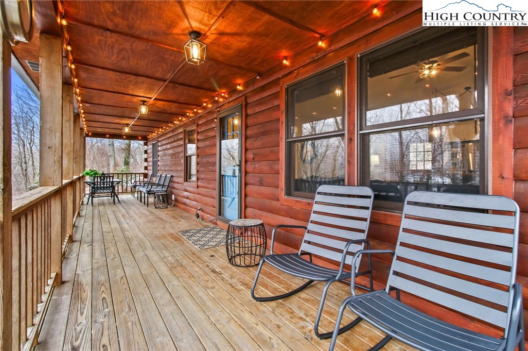 a view of a patio with table and chairs and wooden floor