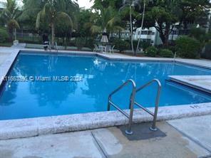 a view of a swimming pool with an outdoor space and seating area