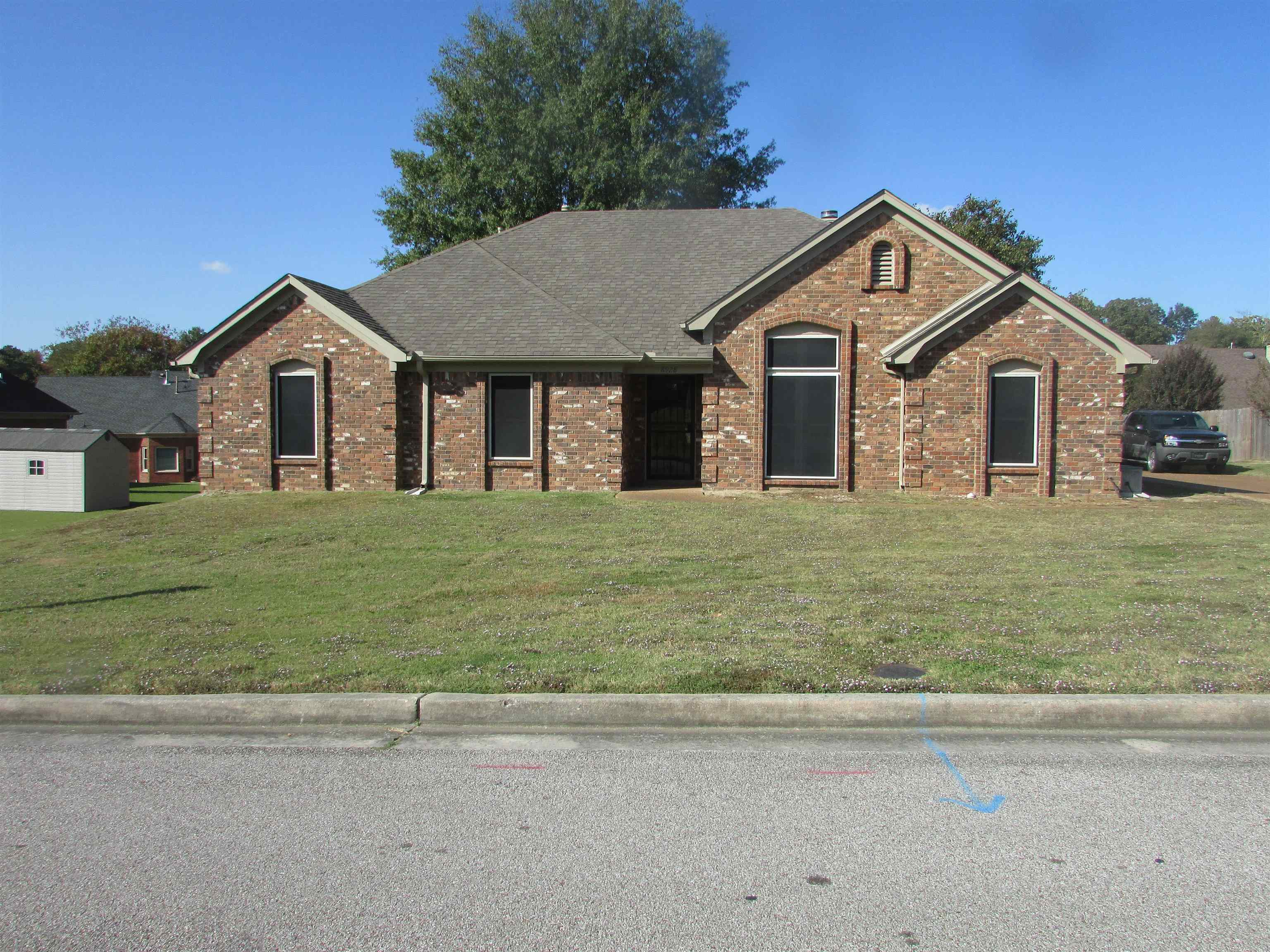 a front view of a house with a yard