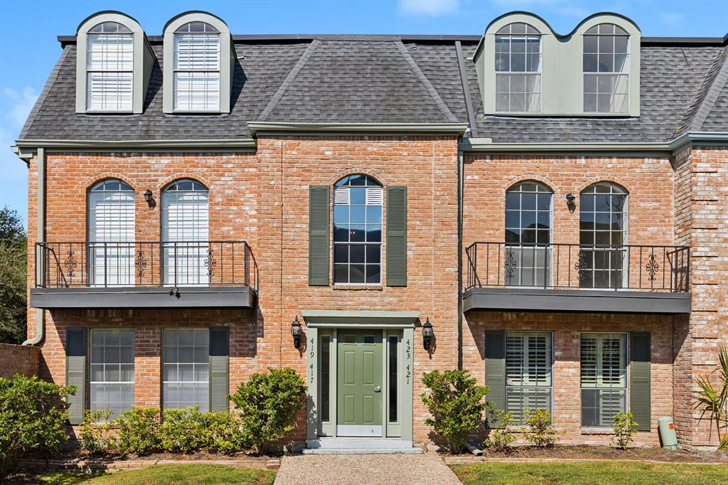 front view of a brick house with a windows