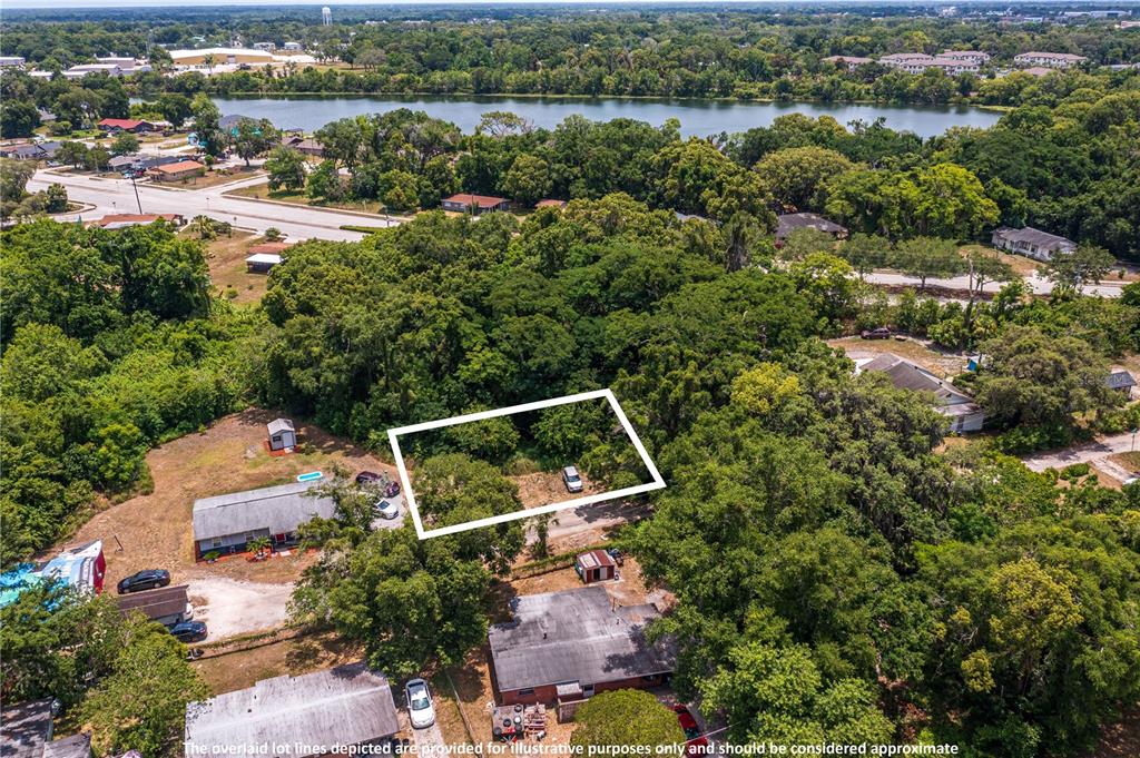 an aerial view of a house with a yard and lake view