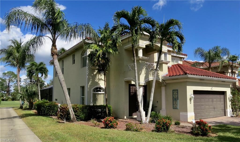 a front view of a house with yard and green space