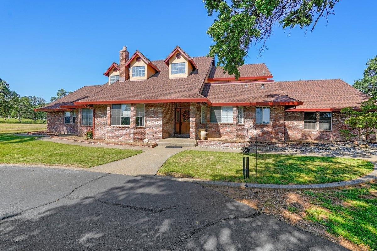 a front view of a house with yard patio and green space