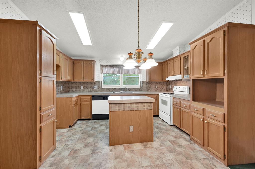 a kitchen with cabinets and window