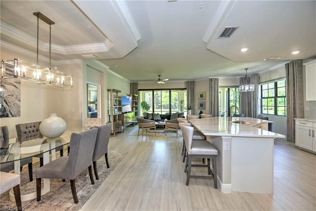 a view of a dining room with furniture wooden floor and chandelier